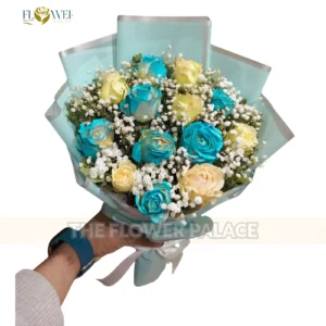 Elegant hand-tied bouquet of blue and white roses in premium blue wrapping for delivery in Islamabad.
