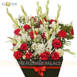 Luxury flower box with red roses, white lilies, and a cute teddy bear for delivery in Islamabad