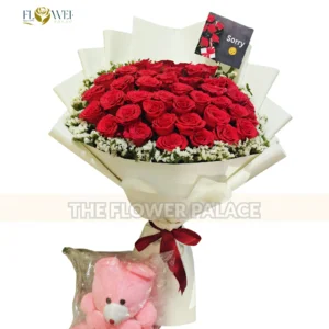 Elegant square gift box with mixed roses, chrysanthemums, and a teddy bear for delivery in Rawalpindi.