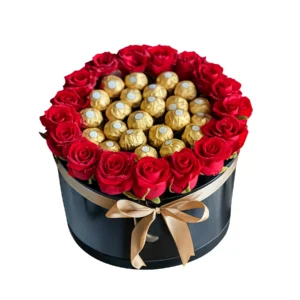 A black gift box filled with red roses and assorted chocolates, elegantly arranged for a special occasion.