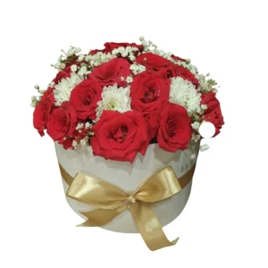 A white box filled with vibrant red roses and delicate white chrysanthemums arranged elegantly.